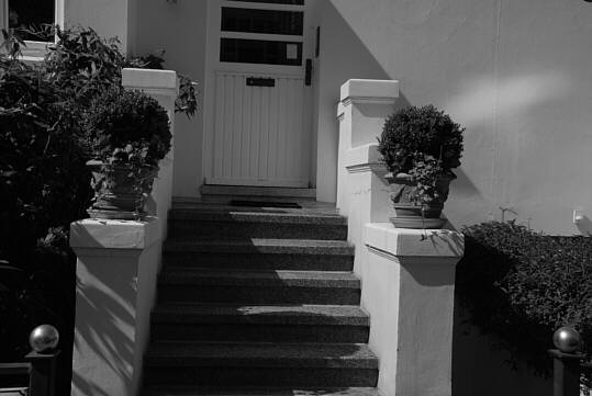 stairs to the entrance of a villa-like townhouse