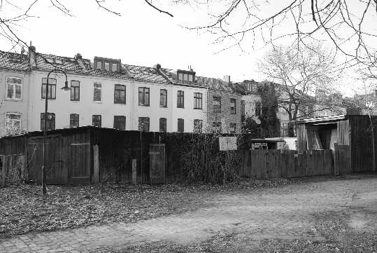Shacks behind big old townhouses
