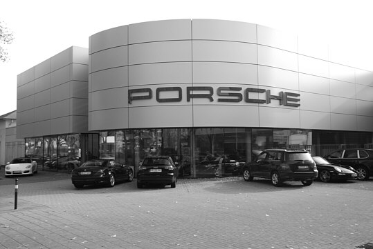 The front of this car dealership appears like a wall made from oversized stones.