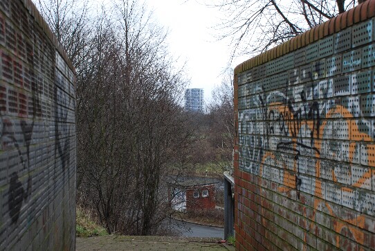 a massive highrise, which is situated in the port area on the right side of the Weser river, seen through an uncommon visual axis