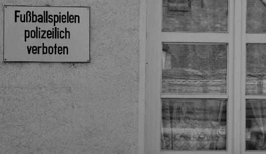 prohibtion sign 'You are forbidden by the police to play soccer'photographed from a different point of view