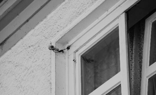 a surveillance camera right in front of a street window