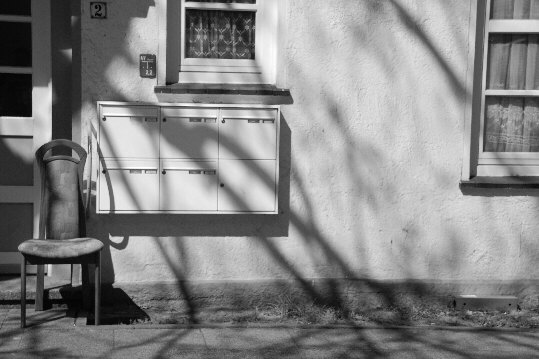 a chair in front of a street door